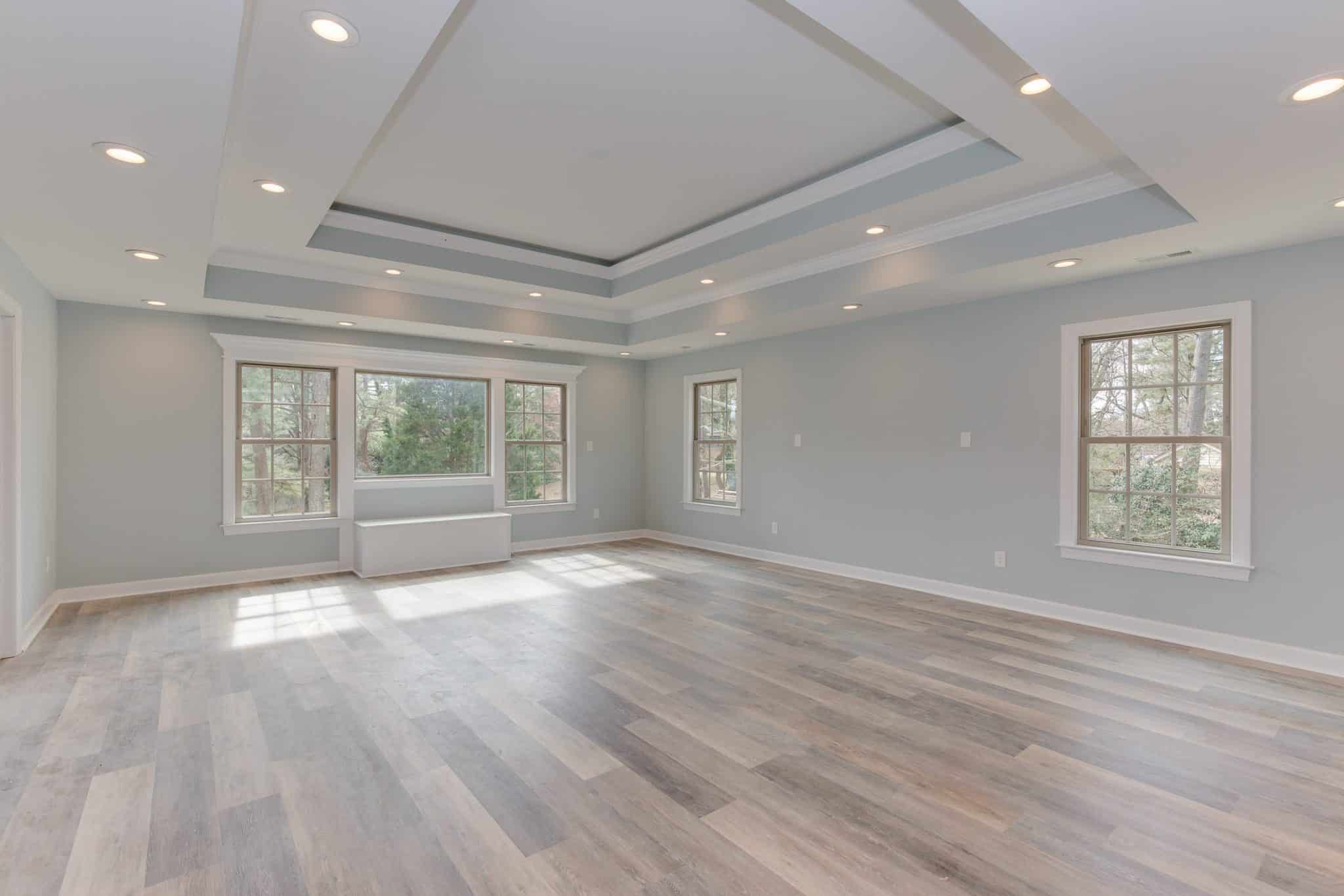 Spacious white living room with vinyl hard wood plank.
