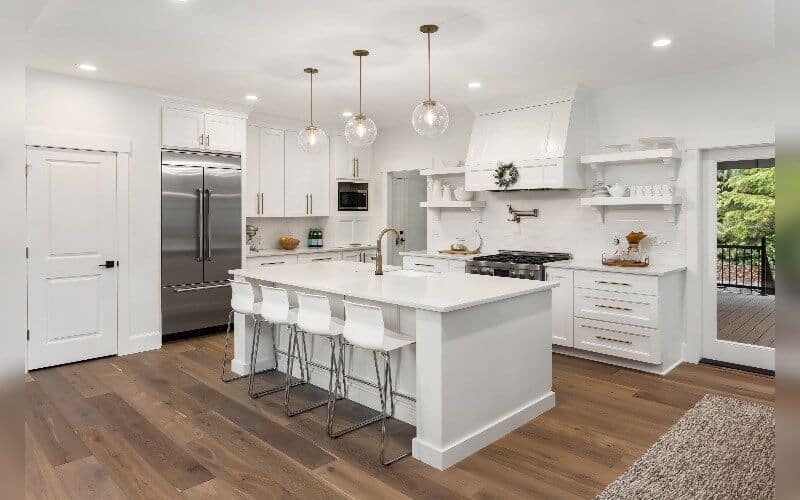 interior shot of an all white modern kitchen with kitchen island