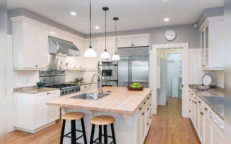 modern white kitchen with white cabinets and steel appliances